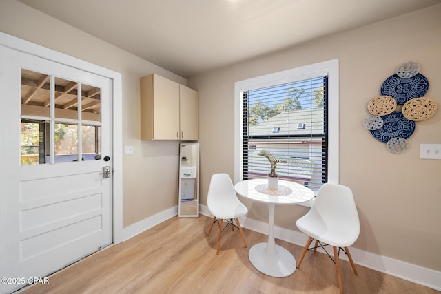 dining room with a healthy amount of sunlight and light wood-type flooring