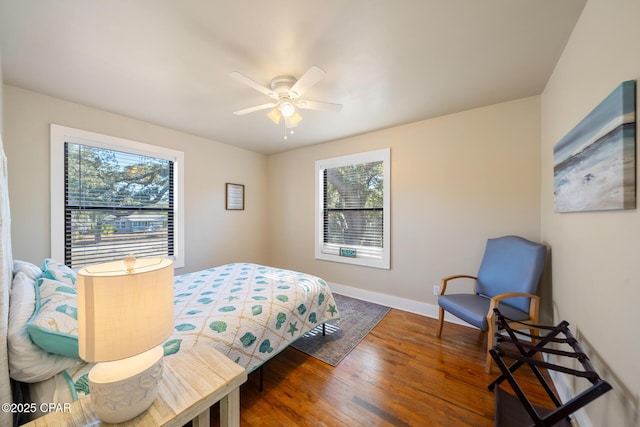 bedroom with ceiling fan and dark hardwood / wood-style flooring