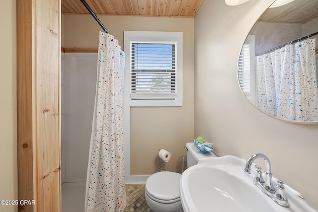 bathroom with sink, curtained shower, tile patterned floors, and toilet