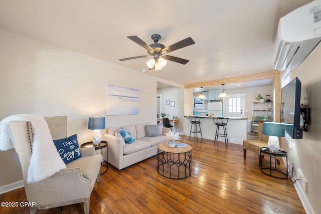 living room with ceiling fan and wood-type flooring