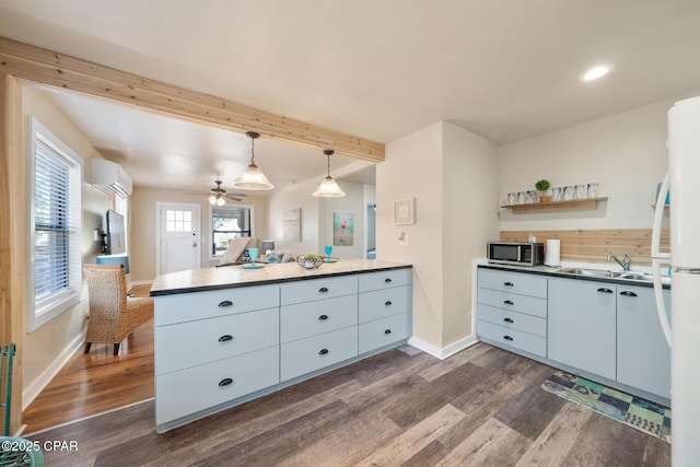 kitchen with hanging light fixtures, sink, dark hardwood / wood-style floors, and white cabinets