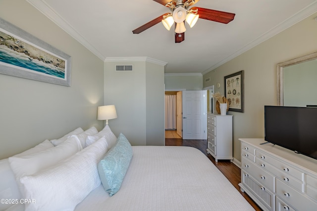 bedroom featuring dark wood-style floors, ceiling fan, visible vents, and crown molding