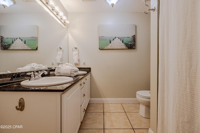 full bath featuring toilet, tile patterned flooring, baseboards, and vanity