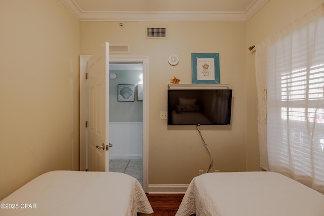 bedroom featuring ornamental molding and visible vents