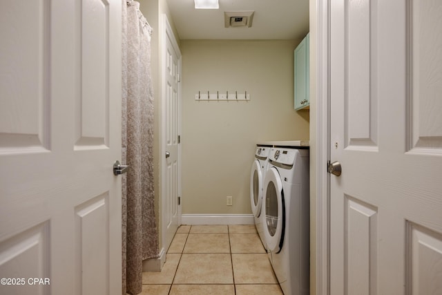 laundry area featuring cabinet space, light tile patterned floors, visible vents, baseboards, and independent washer and dryer