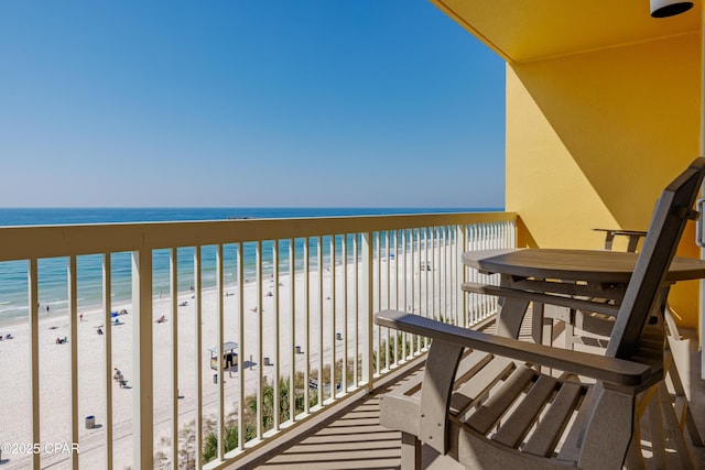 balcony with a water view and a beach view