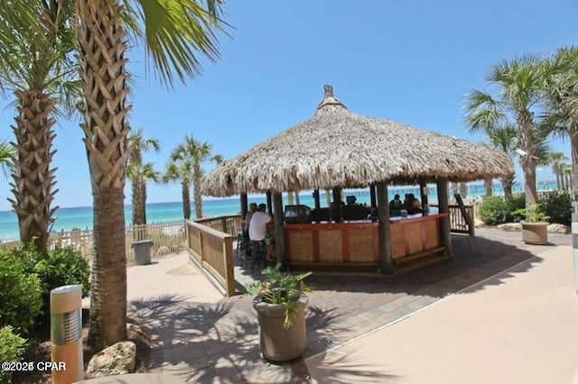 view of patio with a gazebo and a water view