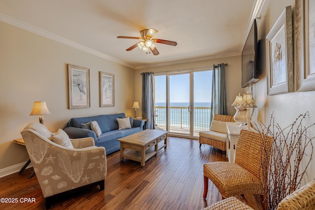 living area with ceiling fan, ornamental molding, dark wood finished floors, and baseboards