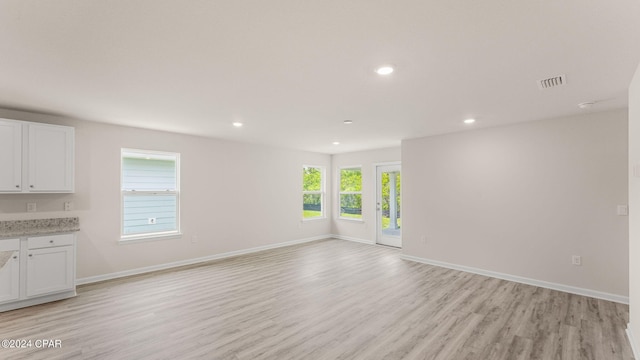 unfurnished living room with light wood-style flooring, recessed lighting, visible vents, and baseboards