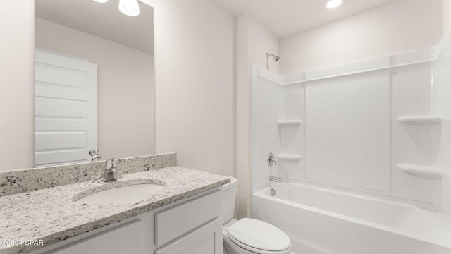 bathroom featuring toilet, vanity, and washtub / shower combination