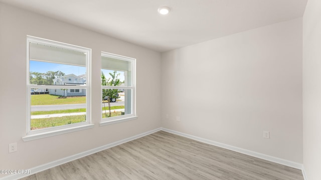 empty room with light wood-style flooring and baseboards