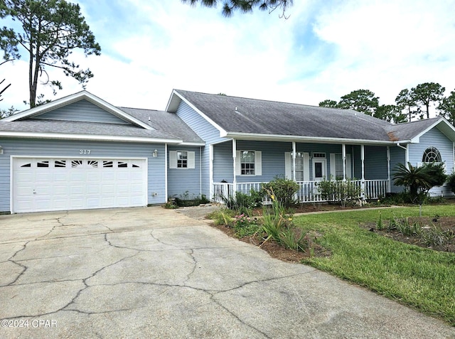 single story home with a porch and a garage