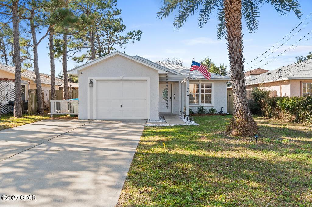 ranch-style house featuring a garage and a front yard