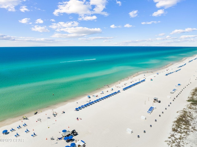 birds eye view of property with a water view and a view of the beach