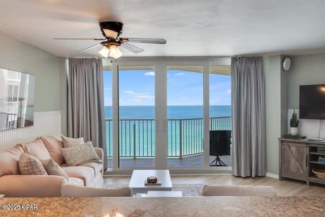 living room with ceiling fan and light hardwood / wood-style floors