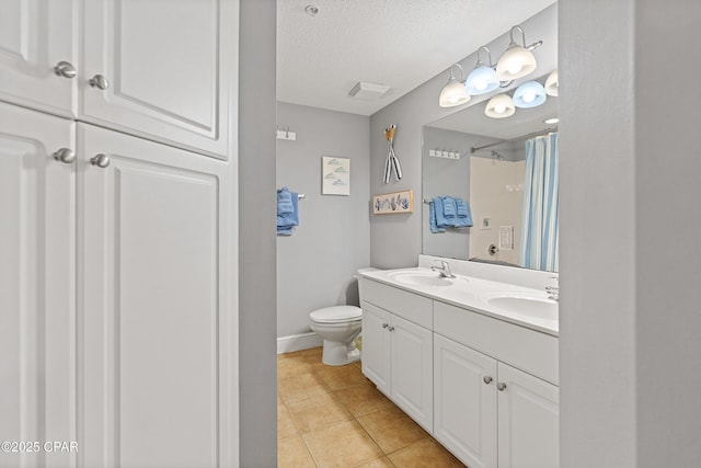 full bath with a textured ceiling, toilet, tile patterned flooring, and a sink