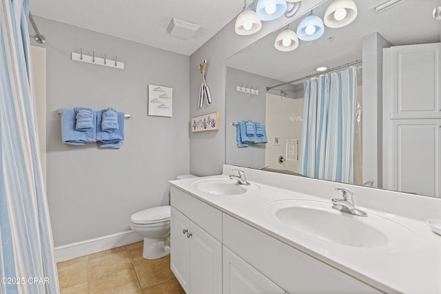 full bathroom with a sink, toilet, a textured ceiling, and tile patterned flooring