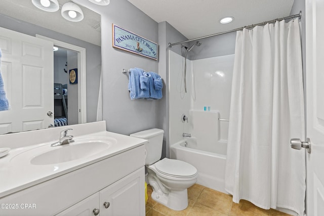 bathroom with tile patterned flooring, toilet, vanity, and shower / bath combo