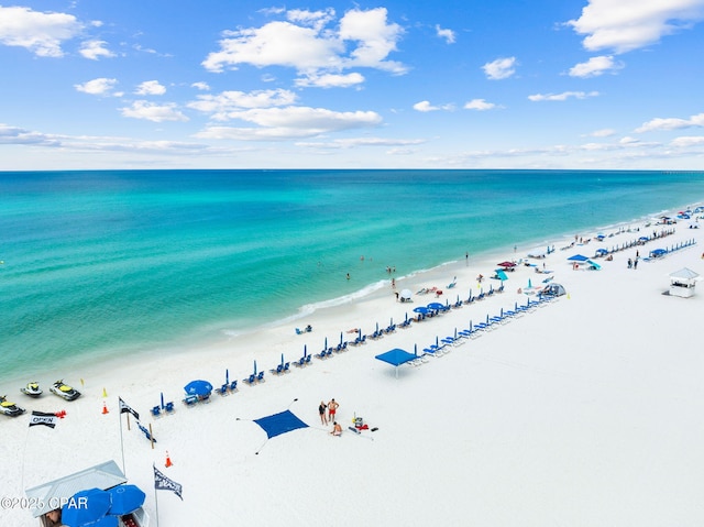 birds eye view of property with a water view and a view of the beach