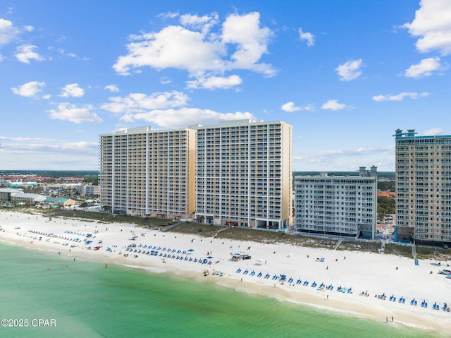 drone / aerial view with a city view, a view of the beach, and a water view