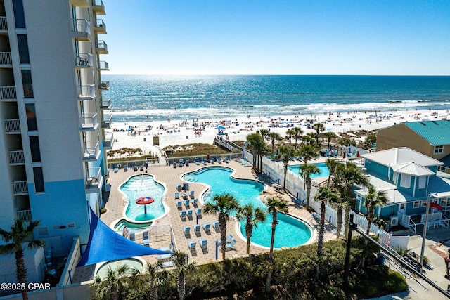 exterior space featuring a beach view and a water view