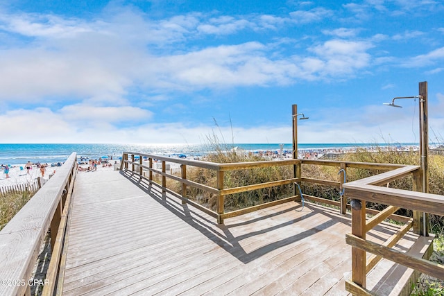 view of dock with a view of the beach and a water view