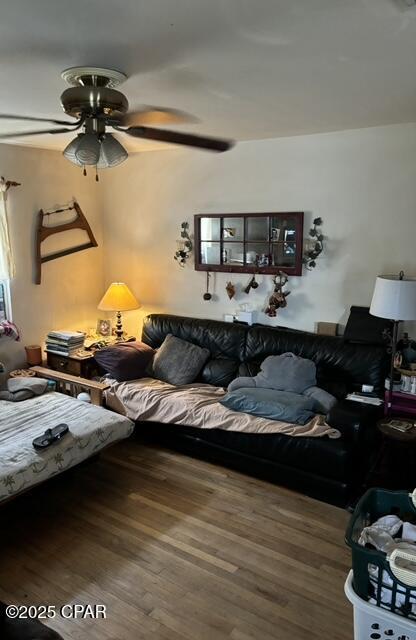 living room with wood-type flooring and ceiling fan