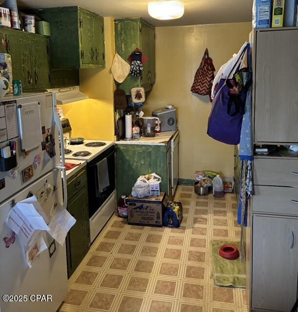 kitchen with white appliances and green cabinetry