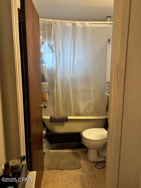 bathroom featuring tile patterned flooring and toilet