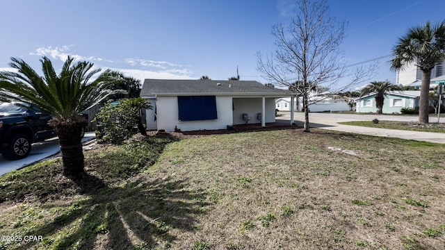 ranch-style home with covered porch and a front yard