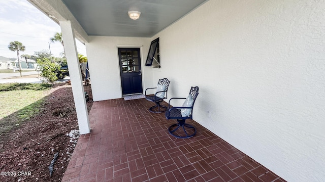 doorway to property featuring covered porch