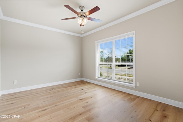 spare room with crown molding, baseboards, ceiling fan, and light wood-style floors