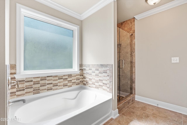 bathroom featuring crown molding, a shower stall, a bath, tile patterned floors, and baseboards