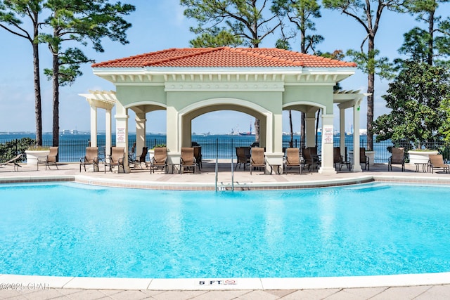community pool featuring a patio and fence
