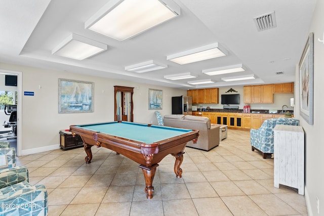 game room featuring visible vents, baseboards, a sink, and light tile patterned flooring