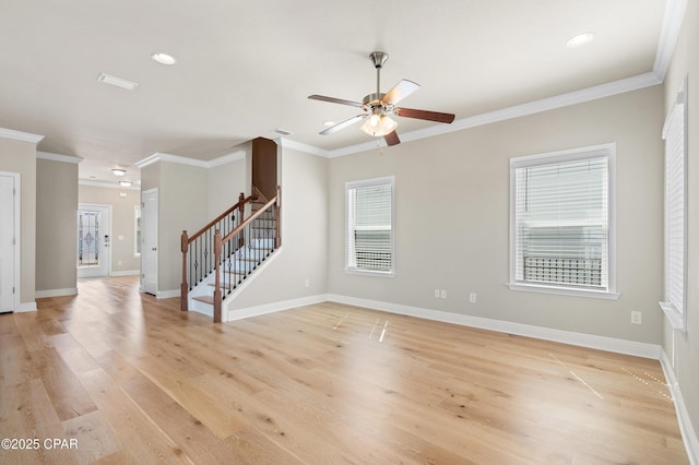 unfurnished living room with crown molding, light wood-style floors, ceiling fan, stairs, and baseboards