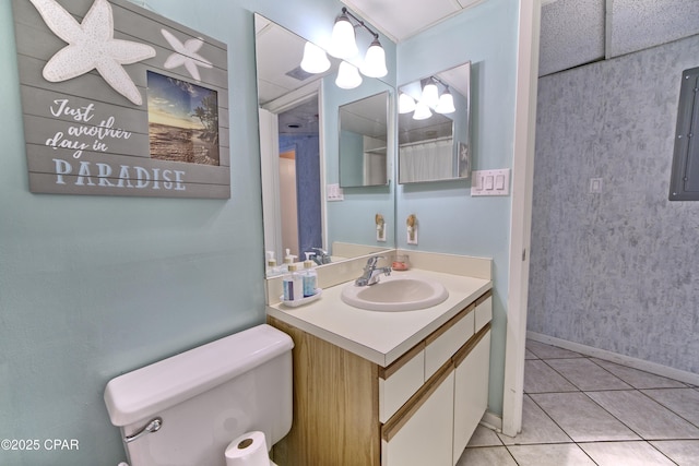 bathroom featuring toilet, electric panel, vanity, and tile patterned floors