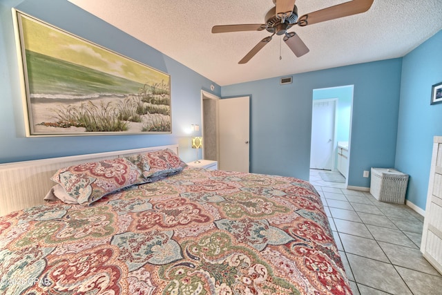 bedroom with visible vents, a ceiling fan, light tile patterned flooring, connected bathroom, and a textured ceiling