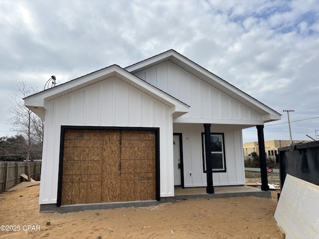 modern farmhouse featuring board and batten siding and an attached garage