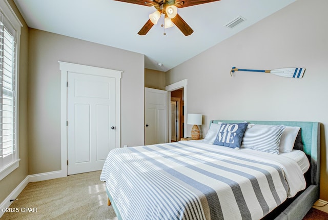 bedroom with light carpet, lofted ceiling, and ceiling fan