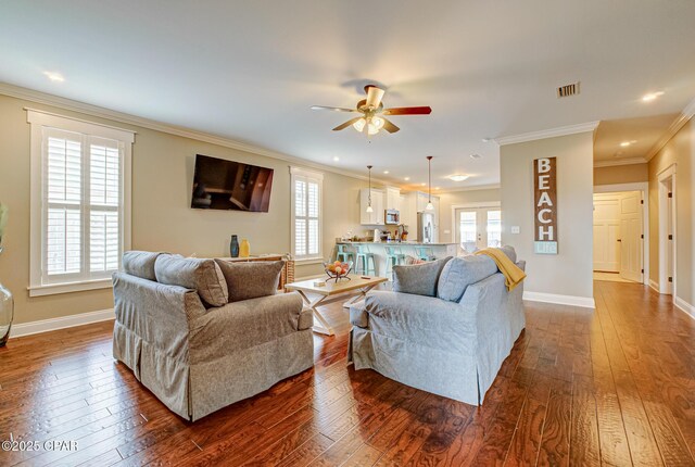 living room featuring crown molding, ceiling fan, and dark hardwood / wood-style floors