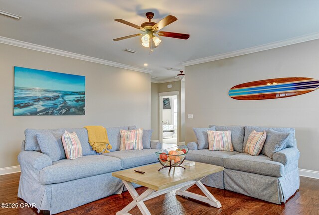 living room with ceiling fan, ornamental molding, and dark hardwood / wood-style floors