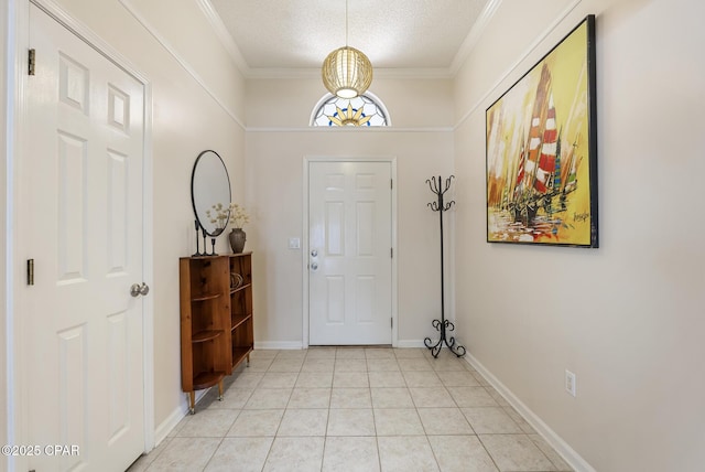 foyer with baseboards, a textured ceiling, light tile patterned flooring, and crown molding