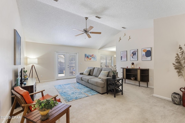 living area featuring visible vents, light carpet, vaulted ceiling, and french doors