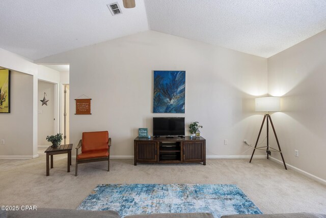 sitting room featuring baseboards, visible vents, carpet floors, and lofted ceiling