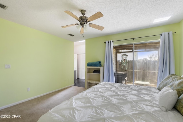 carpeted bedroom with visible vents, a ceiling fan, access to outside, a textured ceiling, and baseboards