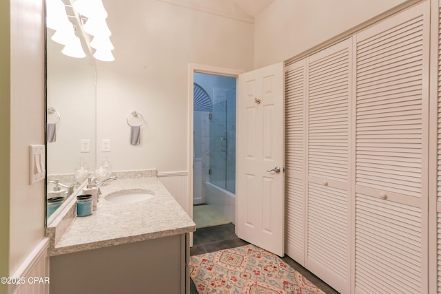 bathroom featuring tile patterned floors, a closet, wainscoting, tub / shower combination, and vanity