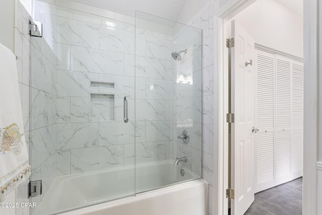 full bath featuring a closet and bath / shower combo with glass door