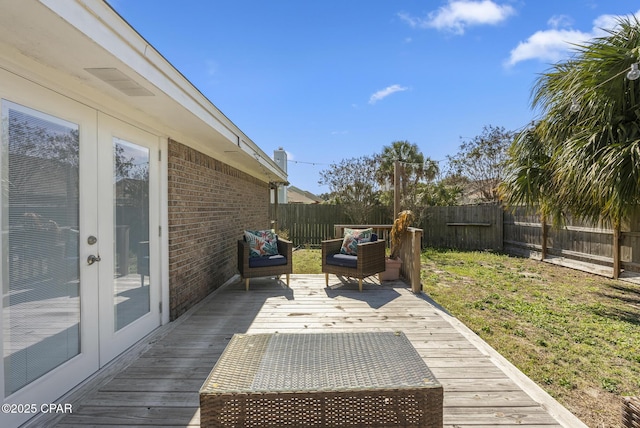 deck featuring french doors and a fenced backyard