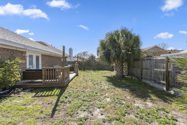 view of yard with a fenced backyard and a wooden deck